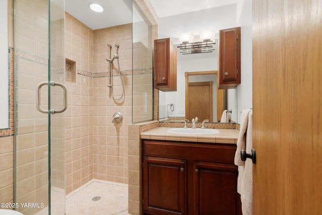 bathroom featuring vanity and a shower stall