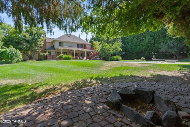 view of yard with stairway and a patio