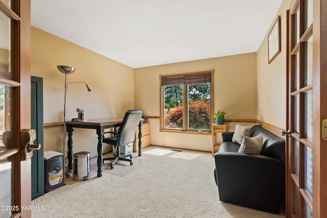 carpeted home office featuring baseboards