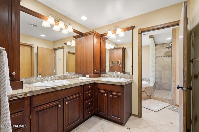 full bath with a sink, visible vents, a stall shower, and double vanity