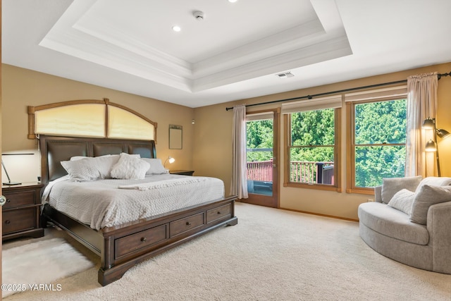 bedroom featuring access to exterior, visible vents, baseboards, carpet, and a raised ceiling