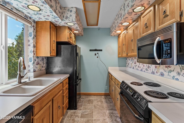 24 Crest Cir, Yakima, WA 98908 - kitchen featuring black appliances, light countertops, brown cabinets, and wallpapered walls
