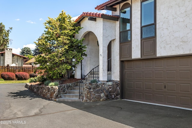 24 Crest Cir, Yakima, WA 98908 - doorway to property with driveway, stucco siding, and a tile roof
