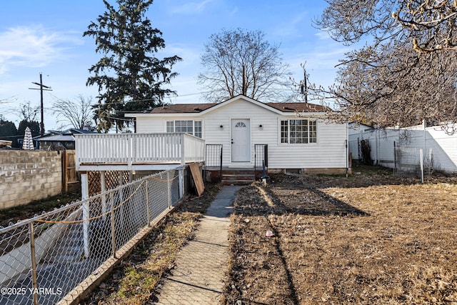 back of house featuring a fenced backyard and a deck