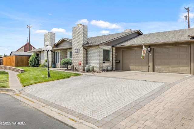 5910 W Lincoln Ave Unit 36, Yakima, WA 98908 - single story home with driveway, a chimney, an attached garage, and brick siding