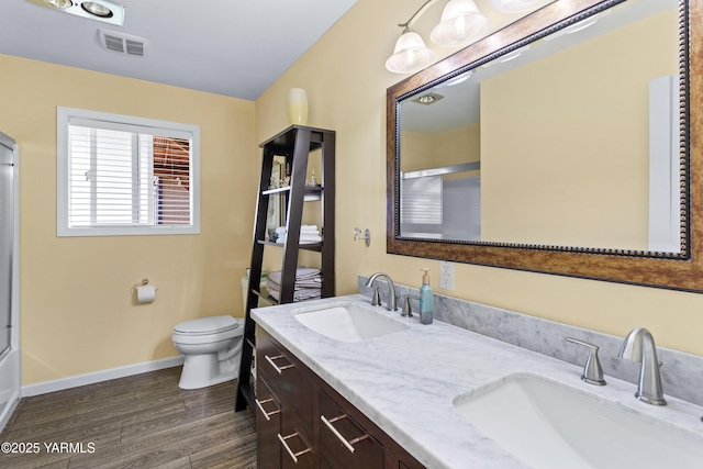 5910 W Lincoln Ave Unit 36, Yakima, WA 98908 - full bathroom with wood finished floors, toilet, double vanity, and baseboards