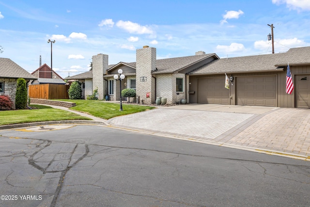 5910 W Lincoln Ave Unit 36, Yakima, WA 98908 - single story home featuring a garage, driveway, a shingled roof, a chimney, and brick siding
