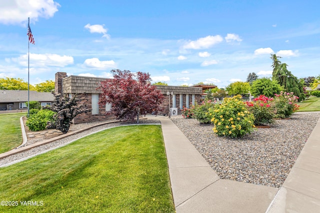 5910 W Lincoln Ave Unit 36, Yakima, WA 98908 - front facade with mansard roof, a front lawn, and stone siding