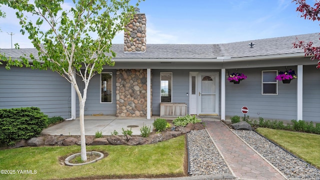 40 Vista Verde Dr, Yakima, WA 98901 - view of front of home with a chimney, a shingled roof, a front lawn, and a patio area
