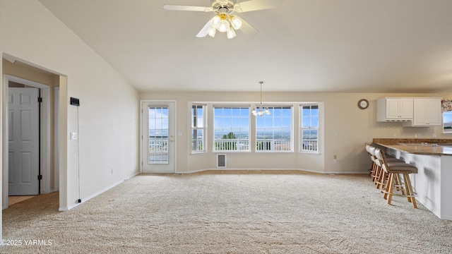 40 Vista Verde Dr, Yakima, WA 98901 - unfurnished living room featuring light colored carpet, lofted ceiling, plenty of natural light, and baseboards