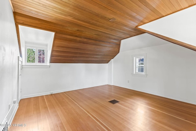 bonus room with lofted ceiling, baseboards, visible vents, wood ceiling, and hardwood / wood-style flooring