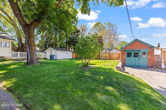 view of yard with a fenced backyard and an outbuilding