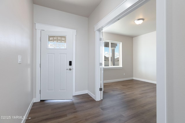 foyer featuring dark wood-style floors and baseboards