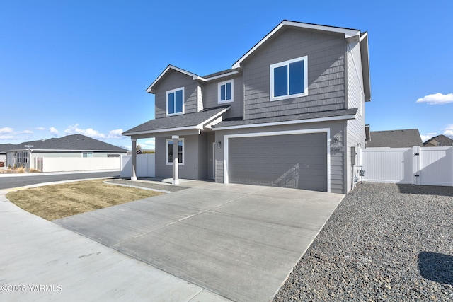 view of front of house featuring concrete driveway, roof with shingles, an attached garage, a gate, and fence