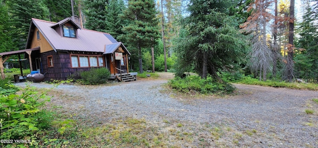 30711 Hwy 410, Naches, WA 98937 - view of home's exterior featuring a metal roof, a chimney, gravel driveway, and a wooded view