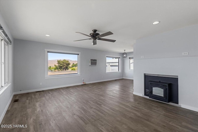 101 Hickory Ln, Selah, WA 98942 - unfurnished living room with a ceiling fan, dark wood-style flooring, recessed lighting, a fireplace, and a wall unit AC