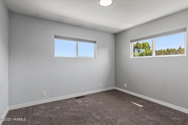 101 Hickory Ln, Selah, WA 98942 - unfurnished room featuring dark colored carpet and baseboards