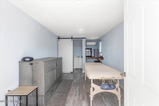 101 Hickory Ln, Selah, WA 98942 - hall featuring a barn door, wood finished floors, recessed lighting, and a wall mounted AC