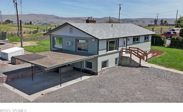 101 Hickory Ln, Selah, WA 98942 - back of house featuring a mountain view, roof with shingles, and a chimney