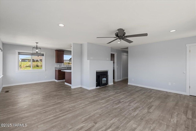 101 Hickory Ln, Selah, WA 98942 - unfurnished living room with wood finished floors, ceiling fan, recessed lighting, and a fireplace