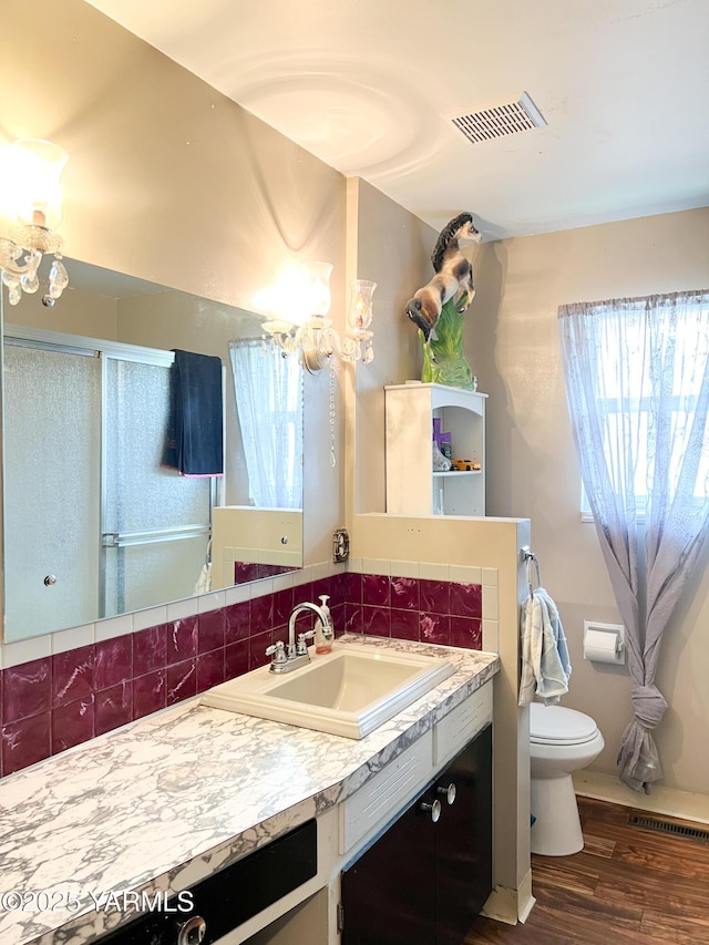 1341 Cemetery Rd, Sunnyside, WA 98944 - bathroom with a chandelier, wood finished floors, toilet, vanity, and a shower with door
