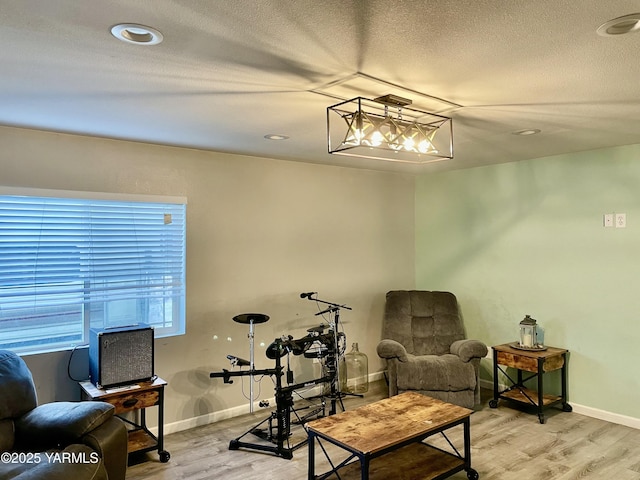 106 S G St, Toppenish, WA 98948 - sitting room featuring baseboards, a textured ceiling, and wood finished floors
