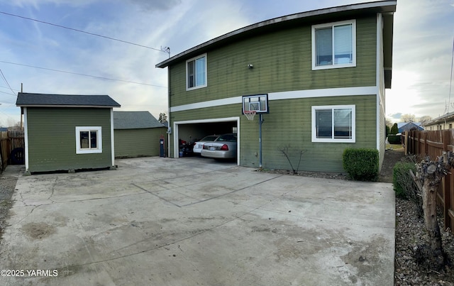 106 S G St, Toppenish, WA 98948 - back of property featuring concrete driveway, fence, and a garage