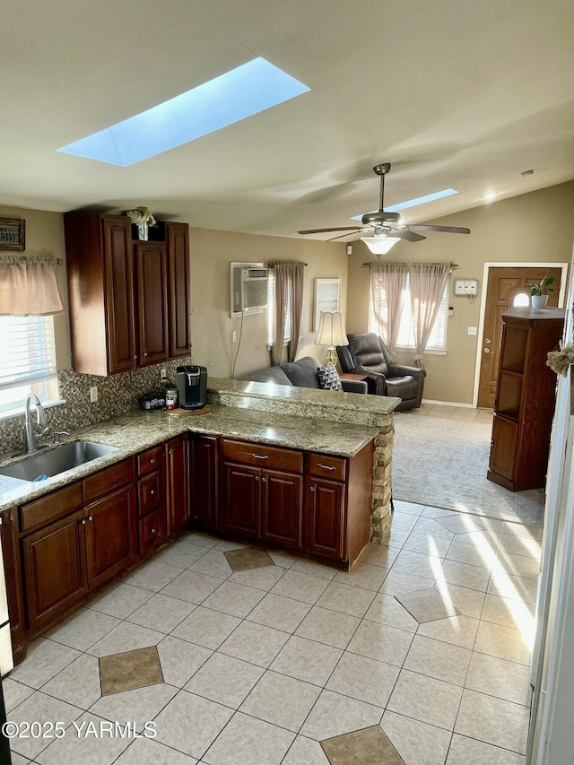 106 S G St, Toppenish, WA 98948 - kitchen with lofted ceiling with skylight, a healthy amount of sunlight, a ceiling fan, and a sink