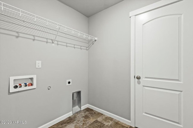 clothes washing area with hookup for a washing machine, hookup for an electric dryer, gas dryer hookup, laundry area, and baseboards