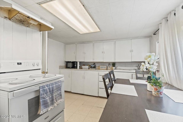 1203 E Chestnut Ave, Yakima, WA 98901 - kitchen with black microwave, extractor fan, white electric range oven, and white cabinets