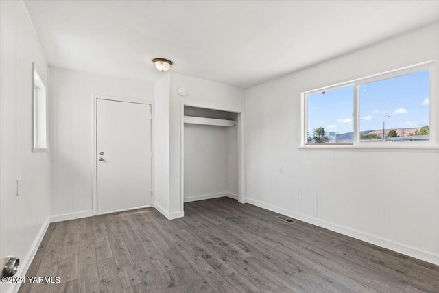 1203 E Chestnut Ave, Yakima, WA 98901 - unfurnished bedroom featuring dark wood-style floors, a closet, visible vents, and baseboards