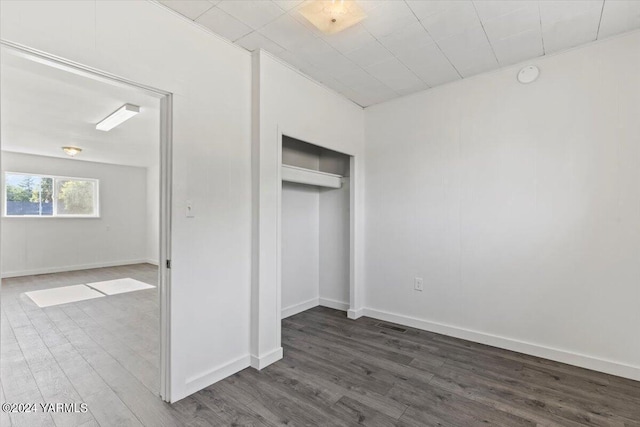 1203 E Chestnut Ave, Yakima, WA 98901 - unfurnished bedroom with a closet, baseboards, and dark wood-type flooring