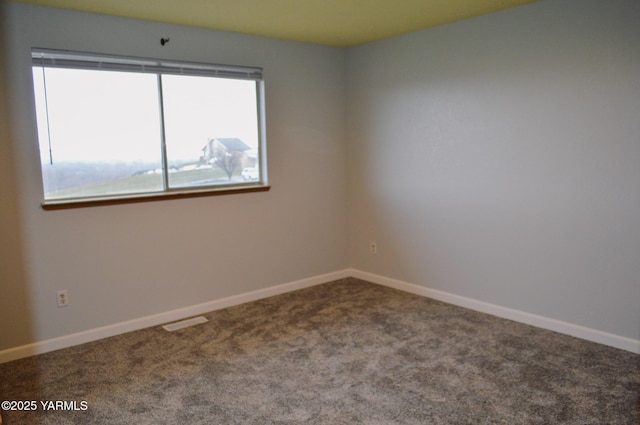 unfurnished room featuring baseboards and carpet