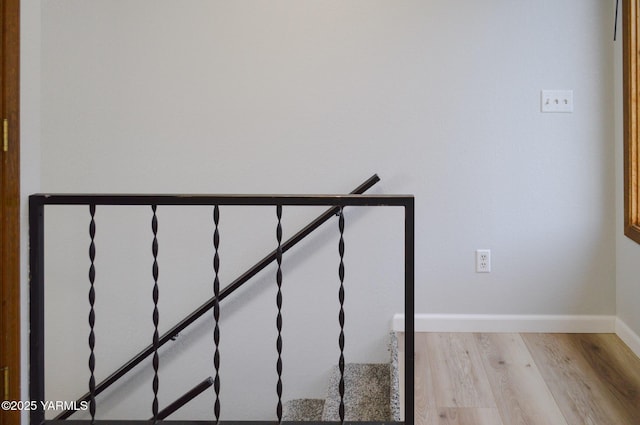 stairway with baseboards and wood finished floors
