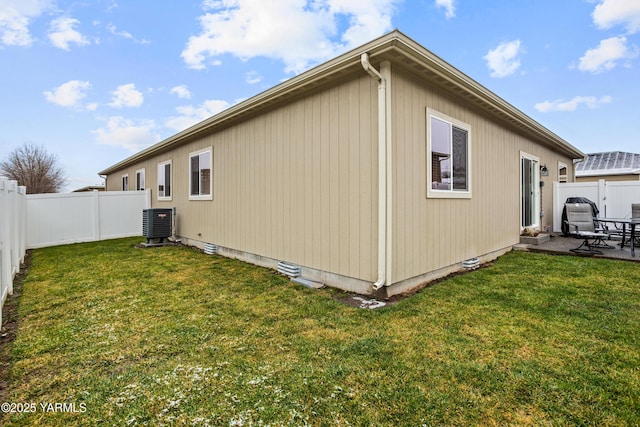 view of home's exterior featuring a yard, central AC unit, and a fenced backyard