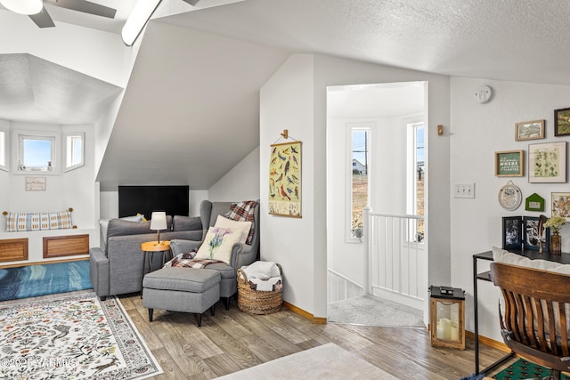 12826 Douglas Rd, Yakima, WA 98908 - living room with wood finished floors, lofted ceiling, plenty of natural light, ceiling fan, and baseboards