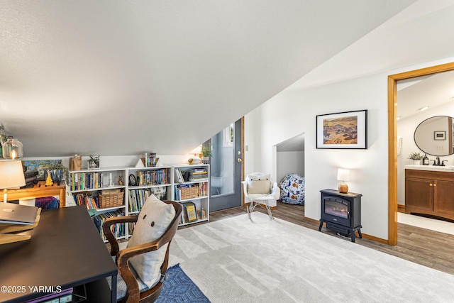 12826 Douglas Rd, Yakima, WA 98908 - office area with a wood stove, wood finished floors, baseboards, and a sink