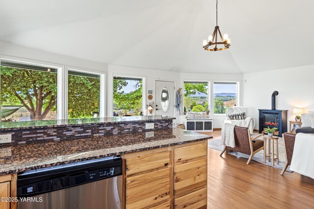 12826 Douglas Rd, Yakima, WA 98908 - kitchen featuring stainless steel dishwasher, open floor plan, a wood stove, a chandelier, and vaulted ceiling