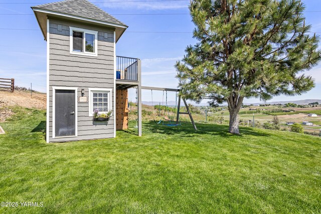 12826 Douglas Rd, Yakima, WA 98908 - rear view of property with a yard, a playground, and roof with shingles