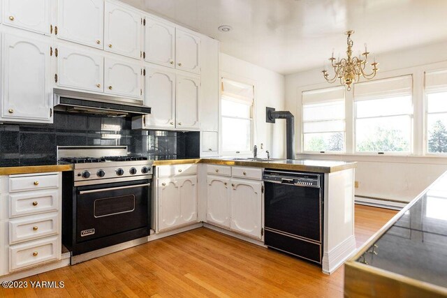 kitchen with luxury range, black dishwasher, dark countertops, white cabinets, and under cabinet range hood