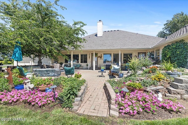 621 Friedline Rd, Yakima, WA 98908 - back of property featuring a chimney, an outdoor living space, a patio, and a shingled roof