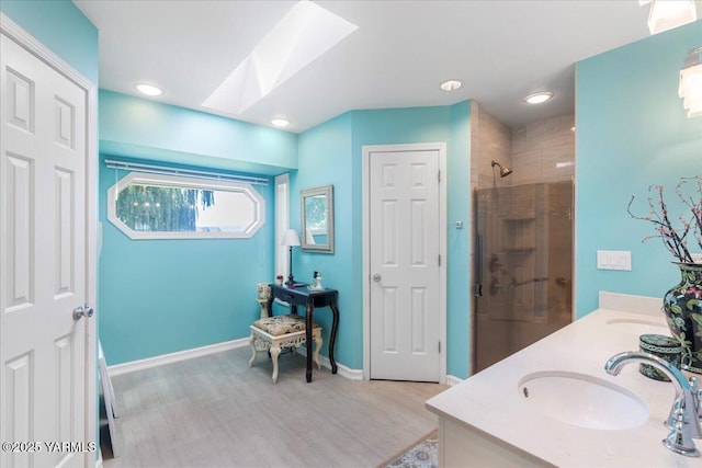 621 Friedline Rd, Yakima, WA 98908 - bathroom with a stall shower, wood finished floors, a skylight, double vanity, and recessed lighting