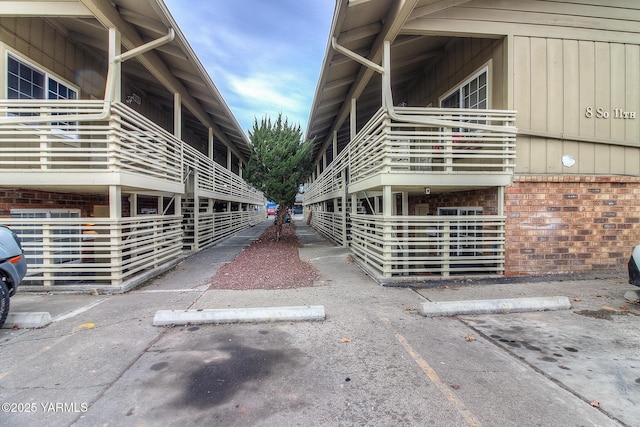 view of building exterior featuring uncovered parking