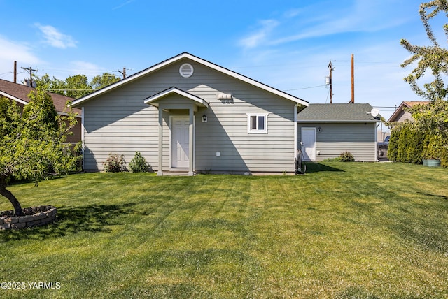 rear view of house with a yard