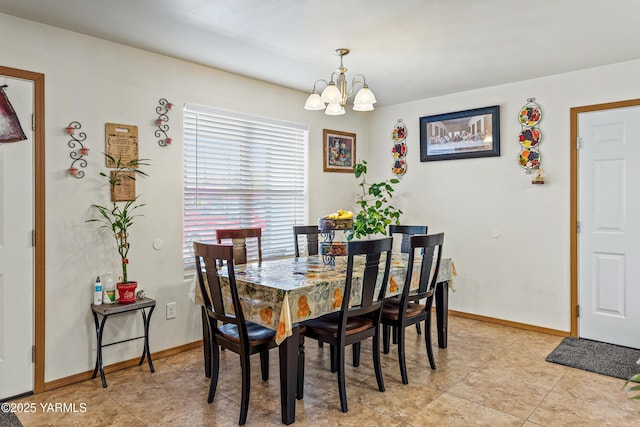 dining area with baseboards, light tile patterned floors, and a chandelier