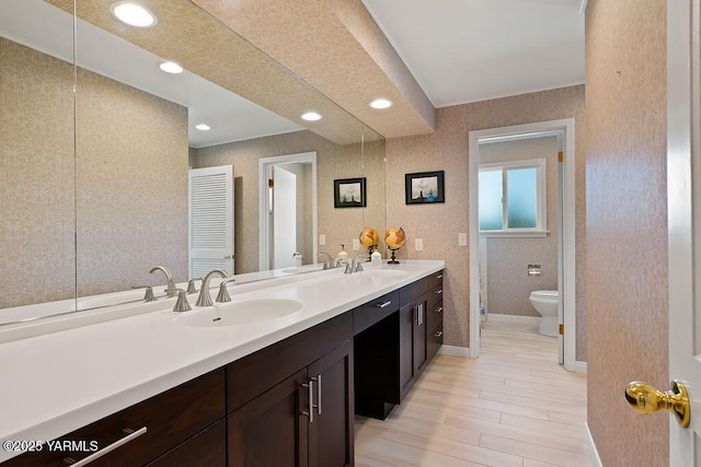 5310 W Lincoln Ave, Yakima, WA 98908 - full bathroom with double vanity, wood finished floors, and recessed lighting