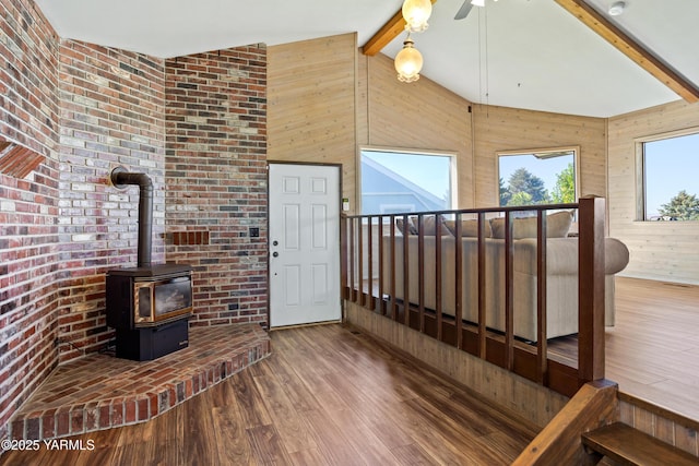 5504 Pear Butte Dr, Yakima, WA 98901 - living area with wood finished floors, a wood stove, wooden walls, and ceiling fan