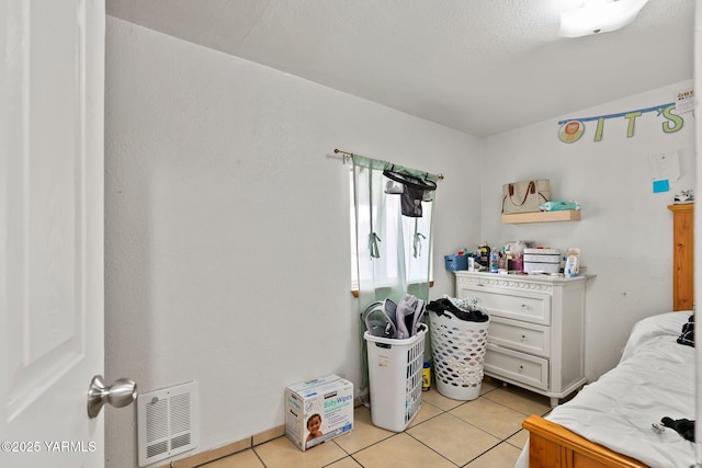 bedroom featuring light tile patterned floors and visible vents