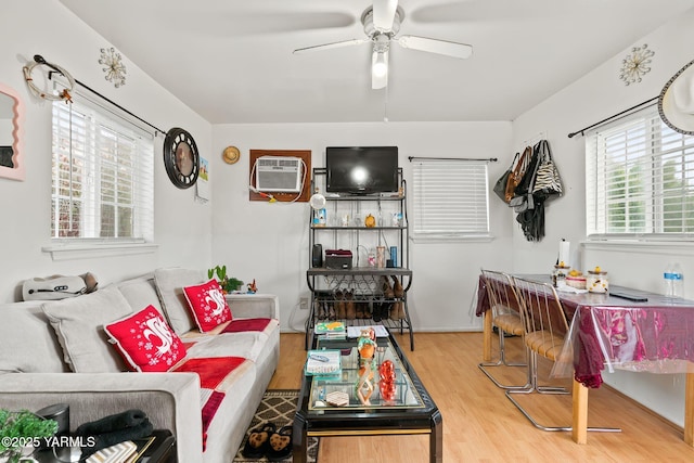 living area with ceiling fan, wood finished floors, and a wall mounted air conditioner