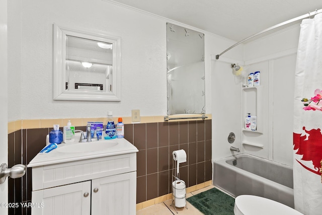 full bathroom featuring toilet, tile patterned floors, shower / bathtub combination with curtain, vanity, and tile walls